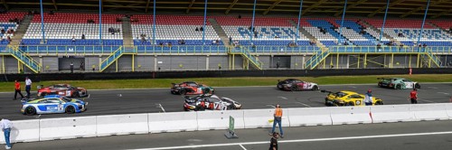 Panoramic photo of part of grid lane with starting grid of racing cars sports cars of GT4 class of