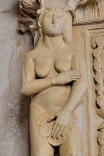 Eve with a fig leaf on the western gate of Trogir Cathedral or Cathedral of St. Lawrence, 13th
