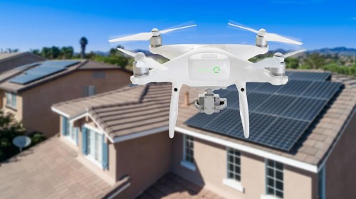 UAV drone inspecting solar panels on large house