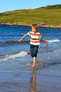 Boy on the beach, Sutherland, Scotland, Great Britain