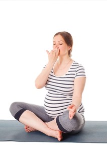 Pregnancy yoga exercise, pregnant woman doing yoga breathing exercise Pranayama isolated on white