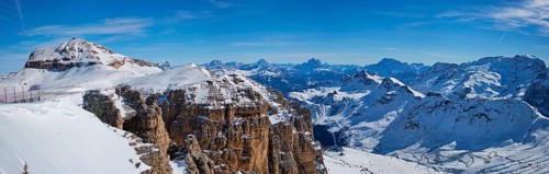 Panorama of a ski resort piste and Dolomites mountains in Italy from Passo Pordoi pass. Arabba,