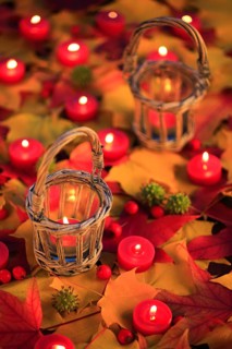 Burning candles, lit candles, different metallic colours