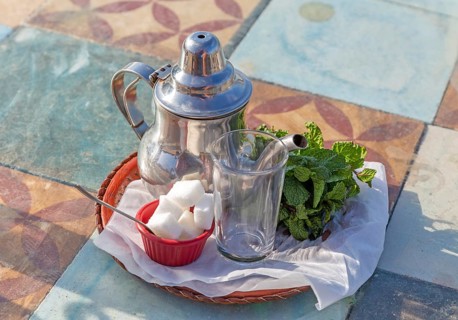 Teapot glass sugar cubes bunch of mint on tea tray for mint tea, Morocco, Africa