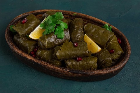 Dolma (Tolma) stuffed rolls, minced meat with rice, in grape leaves, top view, no people, close-up