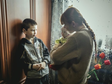 Nasar with his cousin Bogdana and baby Polia in their family home in Voloska Balakliia. The village