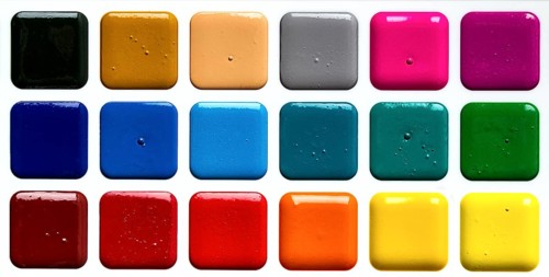 Watercolor paints in a plastic box, on a white background, top view, close-up, no people