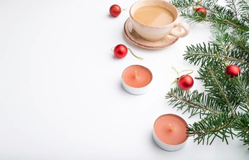 Christmas or New Year composition. Decorations, red balls, fir and spruce branches, cup of coffee,