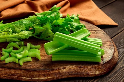 Fresh bunch of celery, top view, no people, on a dark background
