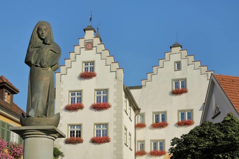 Madonna figure at the fountain and historic gate castle with stepped gable, town gate, town tower,