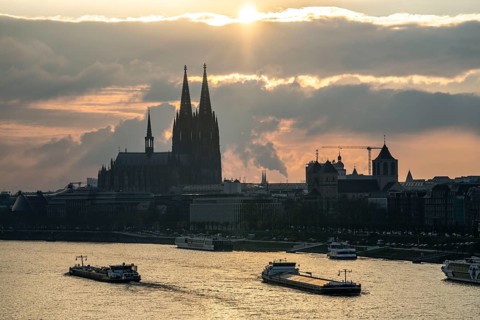 The Rhine near Cologne, sunset, Cologne Cathedral, cargo ship, North Rhine-Westphalia, Germany,