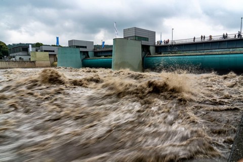Weir of the Lake Baldeney in Essen, the masses of water roar through the open weirs, high water on