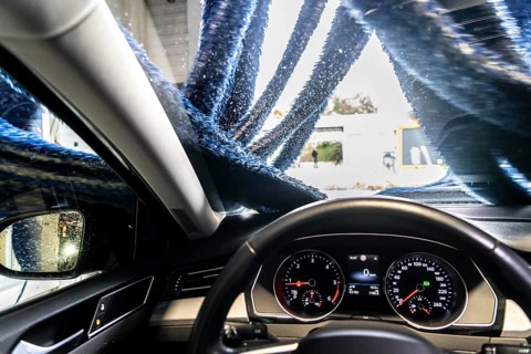 Car in an automatic car wash, car wash tunnel, drying, with hot air and rotating textile cloths