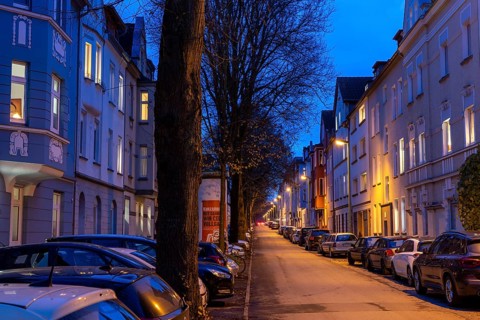 Residential street, many apartment buildings in a residential neighbourhood, evening, lantern
