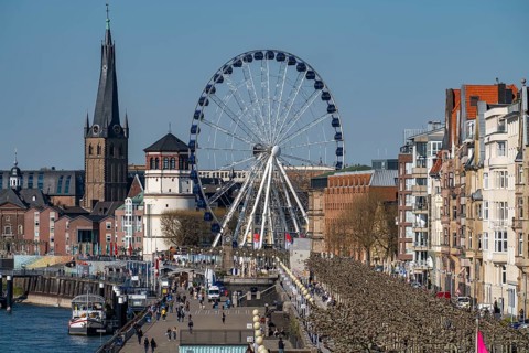 Rhine promenade in Düsseldorf, Ferris wheel, old castle tower, St Lambert's Basilica, old town,