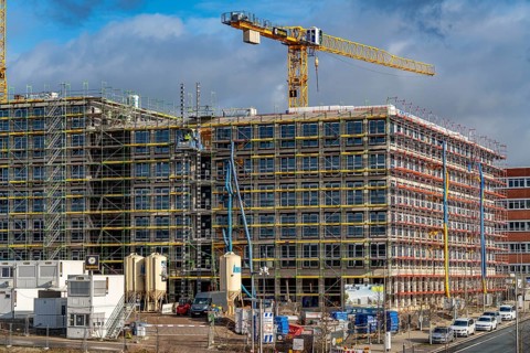 Large construction site, scaffolded shell of an office building complex, O-Werk Campus in Bochum,