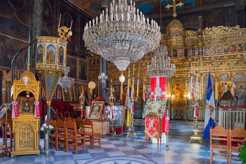 Magnificent interior of an Orthodox church with rich gold jewellery and large chandeliers, Panaghia