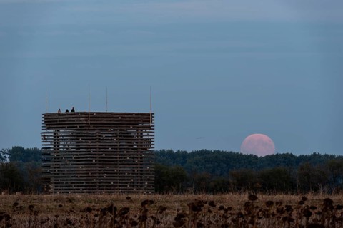 Supermoon rises behind the observation tower of the Ring Shrine Pömmelte, Pömmelte, Saxony-Anhalt,