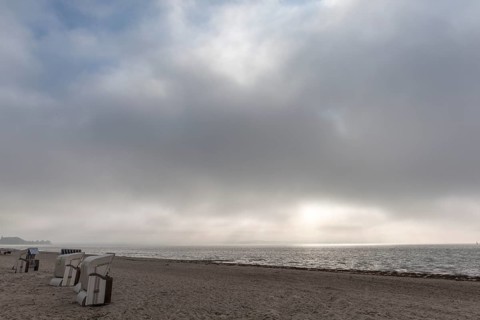 Rain clouds over the Flensburg Fjord, empty beach at Drei, beach chairs, Holnis peninsula, sunlight