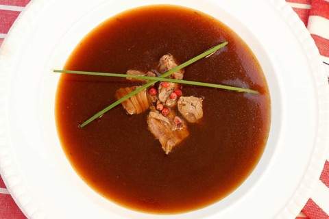 Southern German cuisine, oxtail soup with red pepper in a soup plate, bound soup, meat soup,