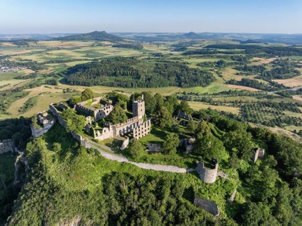 Aerial view of the volcanic cone Hohentwiel with Germany's largest fortress ruins, on the horizon