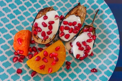 Mediterranean cuisine, roasted aubergines with pomegranate seeds and yoghurt, sweet potatoes,