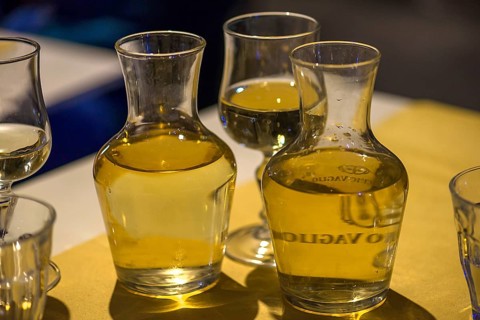 White wine in two small carafes and a glass on the table of a restaurant, Genoa, Italy, Europe