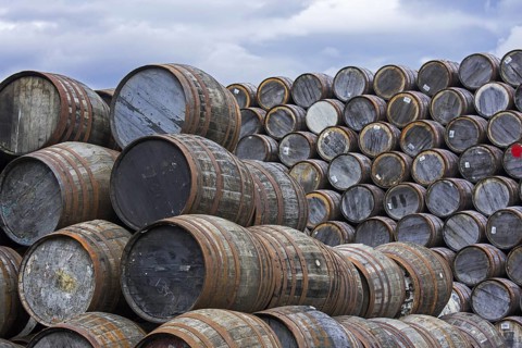 Huge stacks of discarded whisky casks, barrels at Speyside Cooperage, Craigellachie, Aberlour,