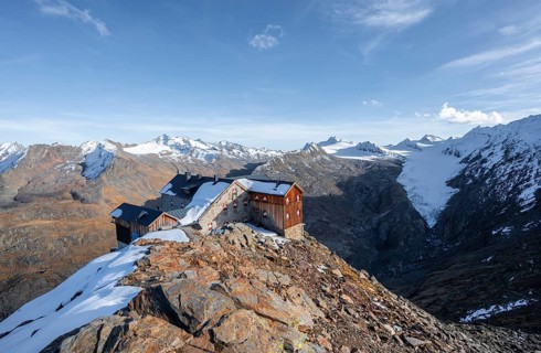 Snowy mountain landscape, mountain hut Ramolhaus in autumn with snow, in the evening light, view of
