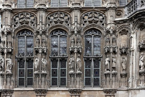 Historic town hall Stadhuis, partial view of the façade in Flamboyant Gothic style with sculptures,