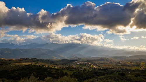 Green landscape with hills under a sunny sky with clouds, Lefka Ori, White Mountains, Mountain