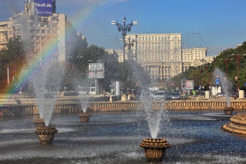City centre, fountains and skyscrapers at Bulevardul Unirii, behind the Palace of Parliament,
