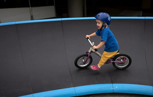 Little girl, 3 years, blonde, helmet, helmet, riding on balance bike, bicycle, skating rink,