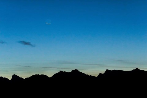 Crescent moon over mountain silhouette, Valais, Swiss Alps