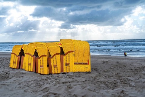 End of the season on the beach, dark storm clouds, choppy sea, autumn on the North Sea in North