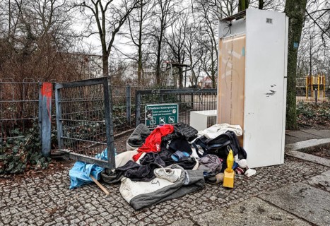 Clothing, a warning light and a refrigerator block the entrance to a public playground, illegal