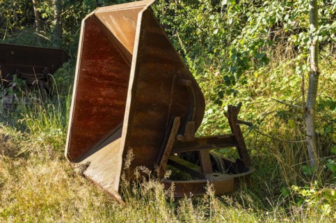 Old dilapidated rusty wagons of a light railway in an abandoned quarry, West Lusatia, Saxony,
