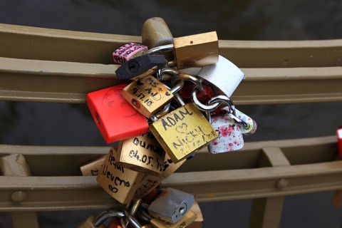 Lover's lock on a railing, love lock is a padlock which, according to custom, is attached to
