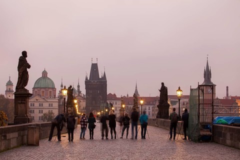 Photographers with tripod and camera on the Charles Bridge in Prague