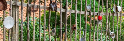 Traditional wooden fence, farm fence, decorated with old pots and utensils, rural idyll, country