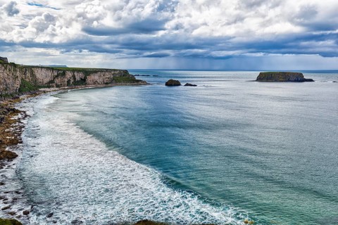 View of the sea, cliff coast, chalk cliffs, dramatic cloudy sky, rain clouds, Causeway Coastal