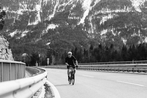 Road bike rider in spring between Lechtal and Tannheimer Tal in front of picturesque scenery of the