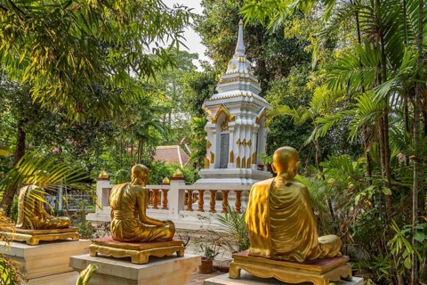 Golden statues of monks in the garden of the Buddhist temple complex Wat Phra Singh, Chiang Mai,