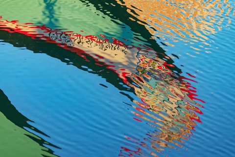 Traditional Moliceiro boat reflected in the water, Aveiro, Portugal, Europe