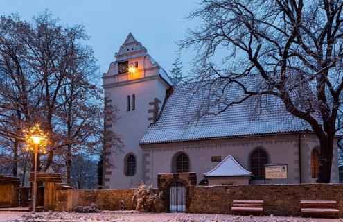 Old church with illuminated poinsettia, snowy and at dusk, Coswig, Saxony, Germany, Europe