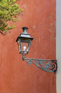 Lantern in front of a red house wall, Seville, Andalusia, Spain, Europe