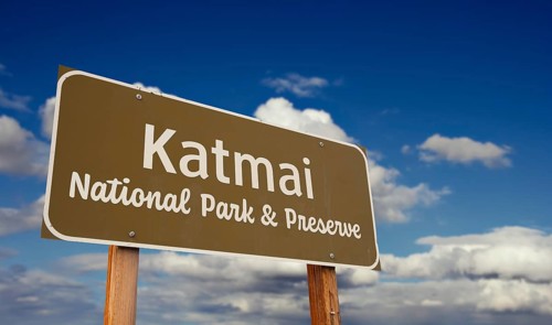 Katmai national park and preserve (alaska) road sign against blue sky and clouds