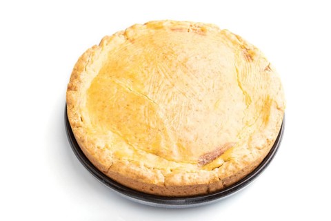 Autumn onion pie and cup of coffee isolated on white background. Side view, close up