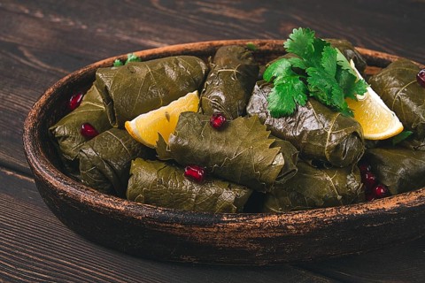 Dolma (Tolma) stuffed rolls, minced meat with rice, in grape leaves, top view, no people, close-up