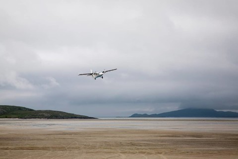 Flybe plane taking off from sandy airstrip Isle of Barra airport, Barra, Outer Hebrides, Scotland,